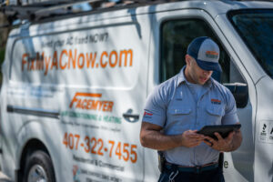 facemeyer-tech-looking-at-tablet-in-front-of-company-van