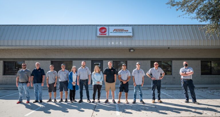 Team in front of building