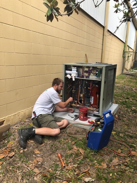 Technician working on heat pump