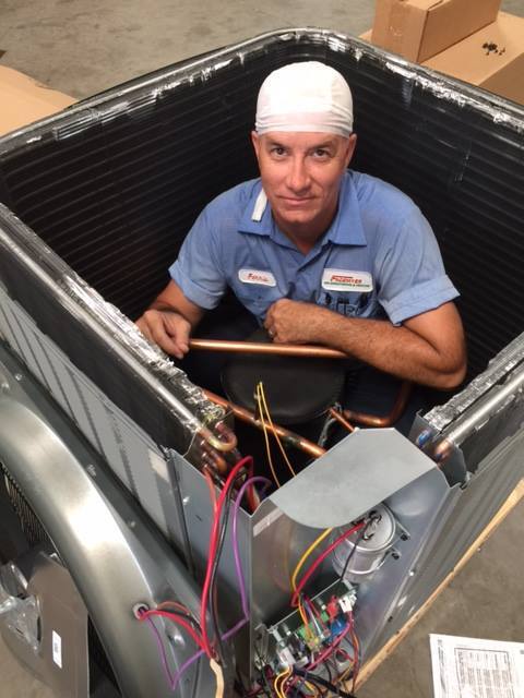Technician-inside-heat-pump