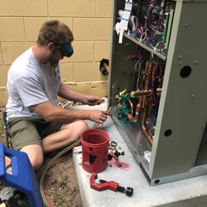 man-working-on-heat-pump