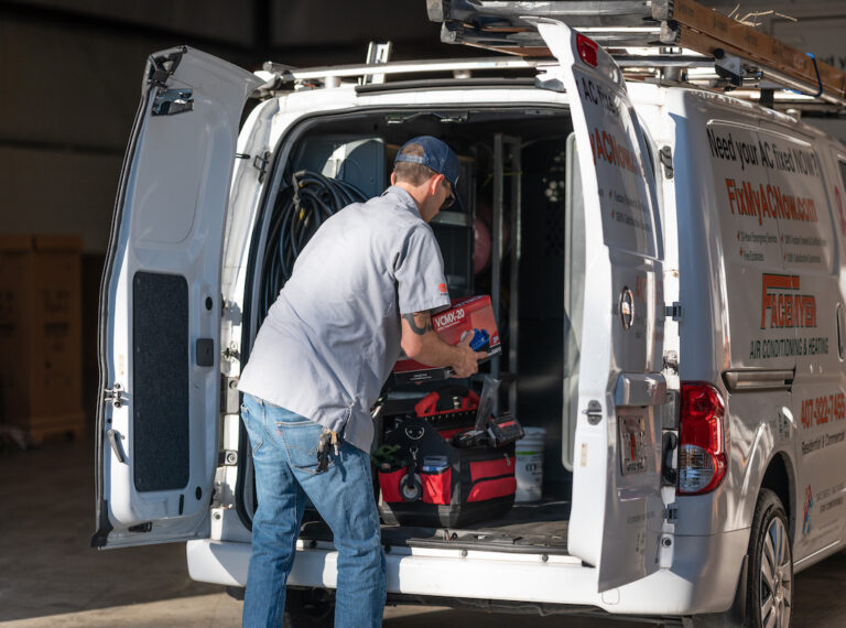Technician-removing-parts-from-van