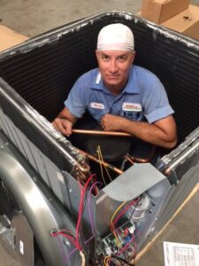 Technician-inside-heat-pump