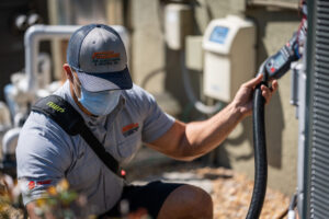 Technician-working-on-heat-pump 2