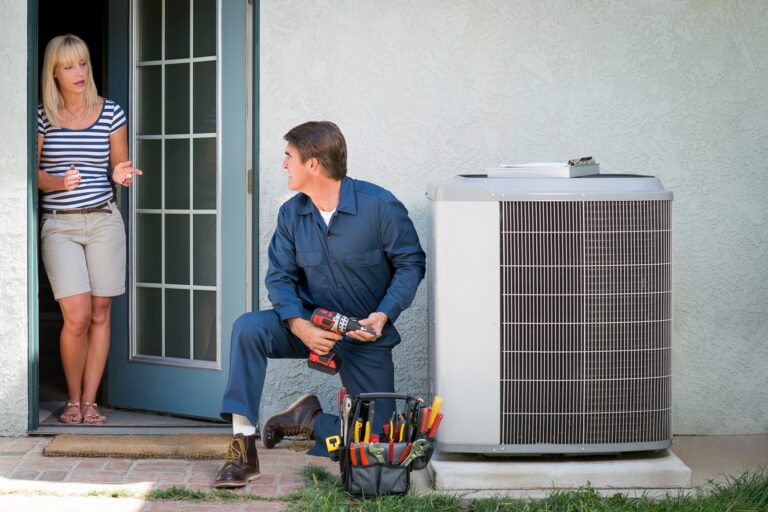 air conditioner technician fixing outdoor unit