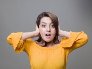 woman-covering-ears-from-AC-noise