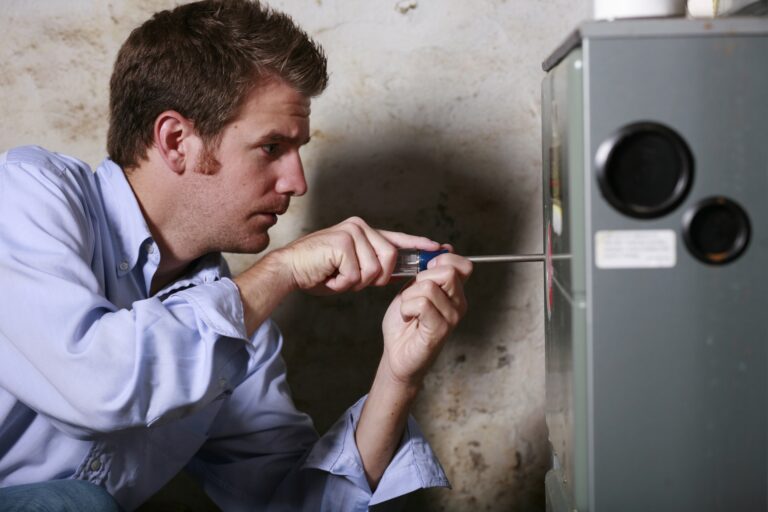 tech unscrewing panel of unit