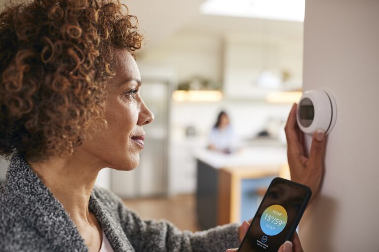 woman checking thermostat